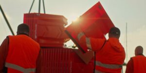 A man carrying the EasyWall water diversion flood barrier.